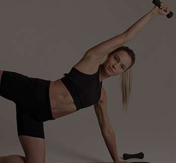 a woman in black clothes holding weights