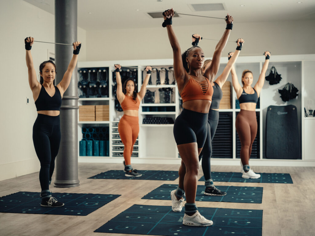 Pvolve Fitness Class - Chicago - Women Exercising with Resistance Bands and the P.Mat